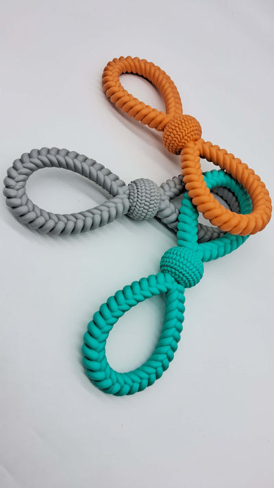 Colorful braided tug toys for dogs, featuring orange, gray, and teal designs, made from durable, non-toxic materials.