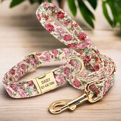 Personalized floral dog collar and leash set with gold hardware featuring the name 'Daisy' and contact info.