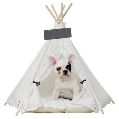 Stylish crochet pet teepee with a cozy cushion and a small dog inside, perfect for indoor lounging.