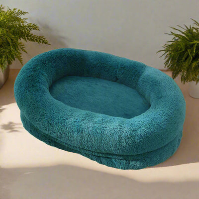 Emerald fluffy oval-shaped pet bed, soft and cozy for dogs or cats, encourages restful sleep and comfort.