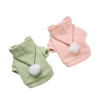 Pastel pet hoodies in green and pink with pom pom balls, perfect for colorful and stylish pet lovers.