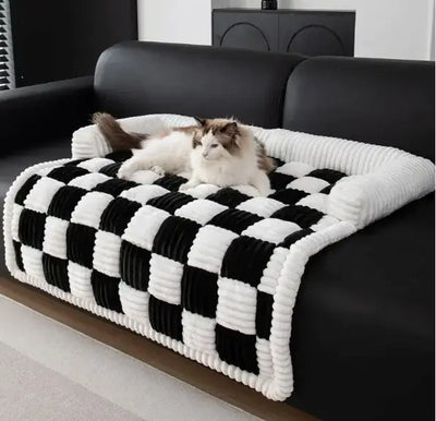 CozyPlush Pet Bed in black and white checkered design, providing comfort for pets on a modern couch.
